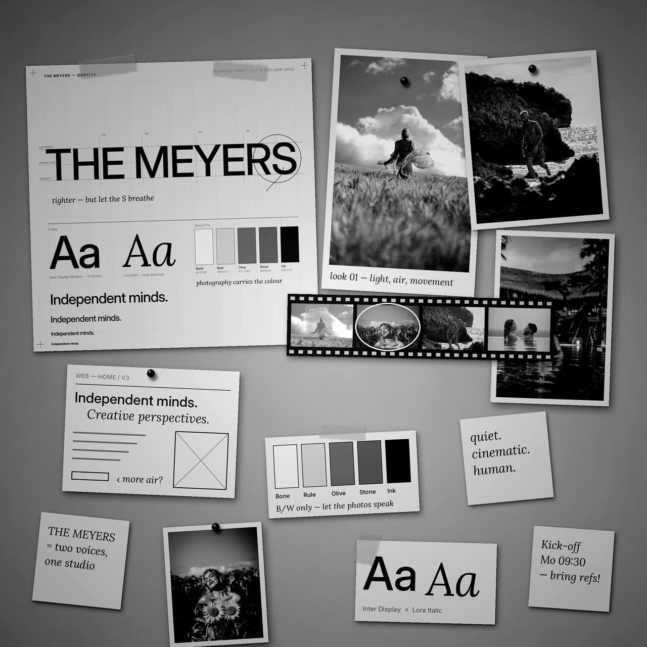 Moodboard and identity working sheets pinned to a studio wall.